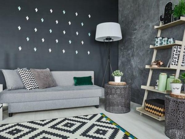 Room with black cactus wall decor and sofa
